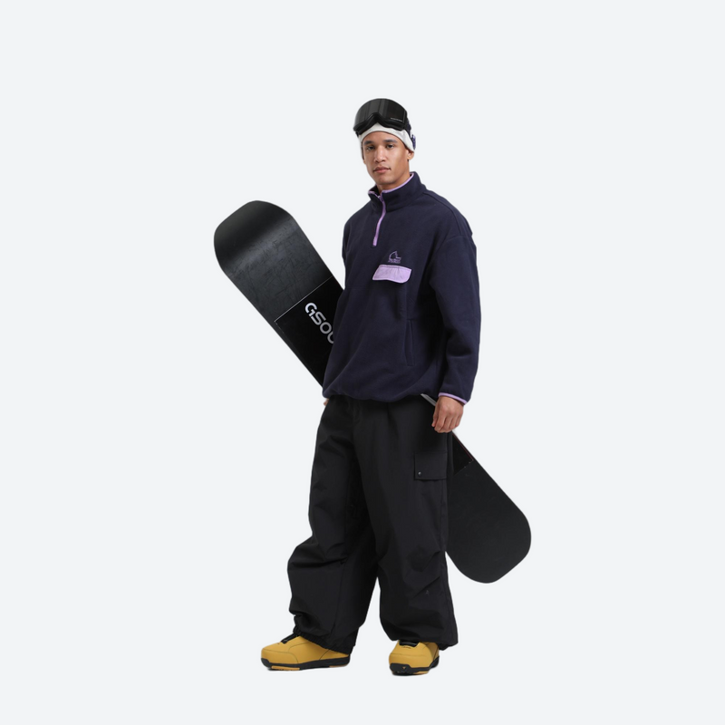 3-layer snowboard cargo pants - black snow pants, on-model front holding snowboard horizontal, for cold-weather winter sports