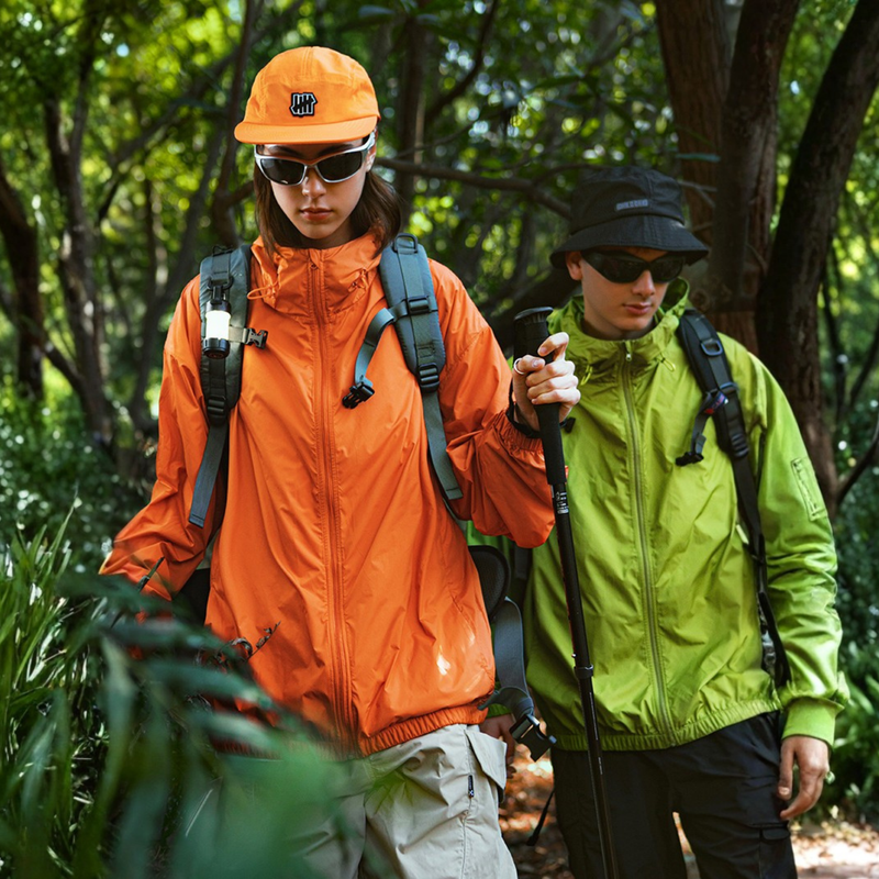 Stain-proof hooded sun jacket for outdoor - orange and neon green waterproof sun jacket on couple, for cycling and commuting