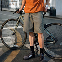 
                  
                    Breathable ripstop trail pants and shorts collection - gray shorts with orange tee, for travel and city walks
                  
                