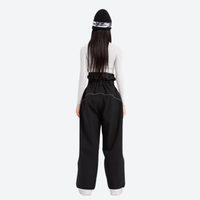 
                  
                    Women's colorblock snowboard jacket with wide-leg pants - black wide-leg snow pants with white top, on-model back view
                  
                