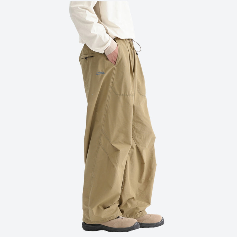 Water-repellent nylon hiking pants with relaxed fit - khaki tan wide-leg hiking pants with cream top