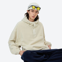 
                  
                    Soft relaxed mid-layer pullover for outdoor - cream hooded mid-layer pullover with beanie and sunglasses, sitting pose view
                  
                