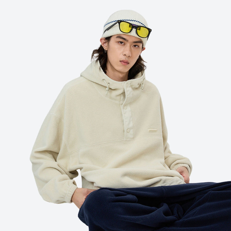 Soft relaxed mid-layer pullover for outdoor - cream hooded mid-layer pullover with beanie and sunglasses, sitting pose view