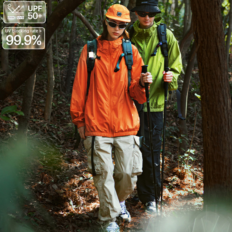 Waterproof sun protection jacket UPF50 - orange and neon green waterproof sun jacket on couple, for hiking and trail walking