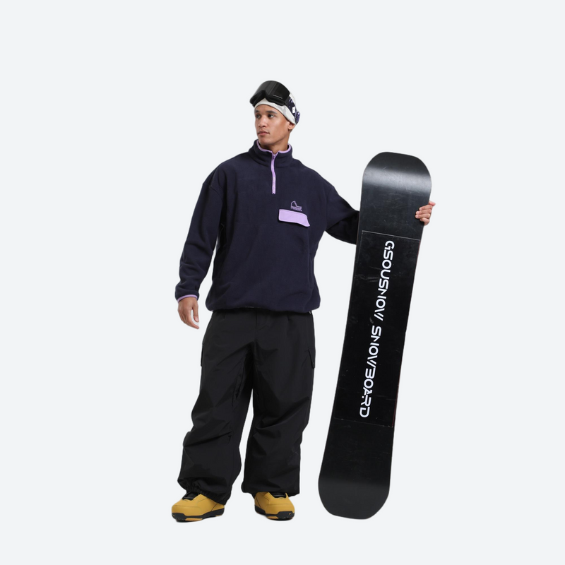 Waterproof 3L cargo snow pants - black snow pants, on-model front with upright snowboard, for skiing and snowboarding