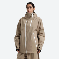 
                  
                    Women's breathable 2-layer snowboard jacket and pants - tan, on-model three-quarter front view, for resort and street wear
                  
                