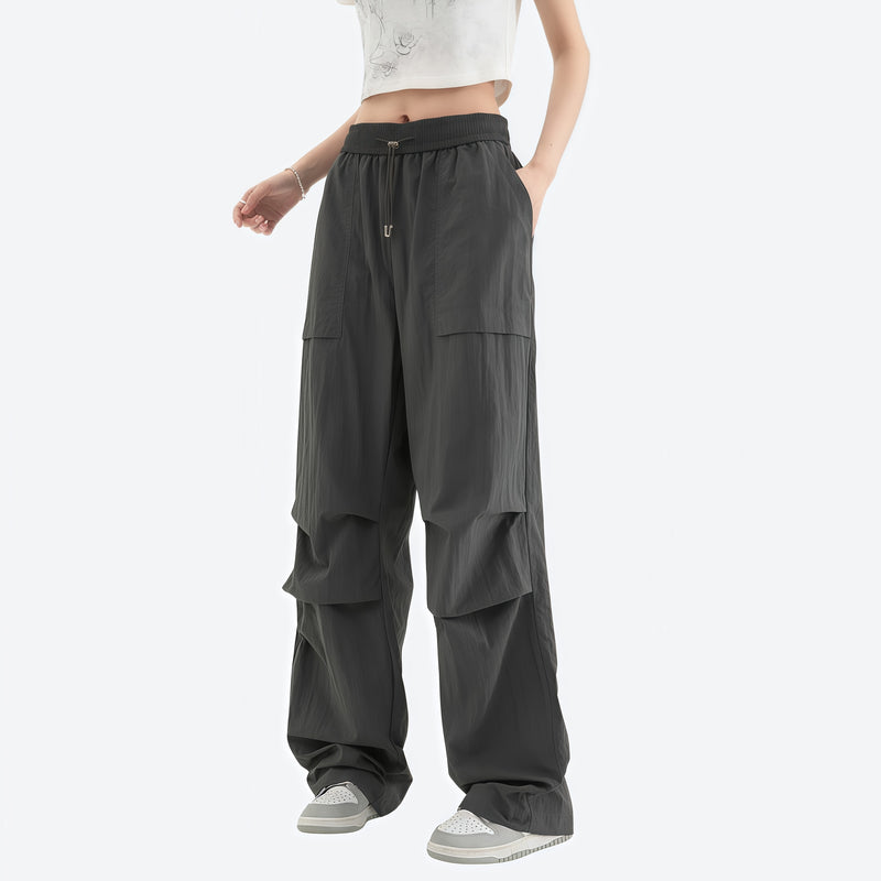 Women's quick-dry trail pants converting to shorts - dark gray zip-off hiking pants with white top, for travel and city walks