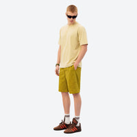 
                  
                    Lightweight quick-dry outdoor wear with tear-resistant fabric - olive shorts with yellow tee, for warm-weather trekking
                  
                