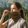 Merino neck gaiter for hiking running and cycling - brown merino wool neckwarmer on women pulling up, worn pull-up view