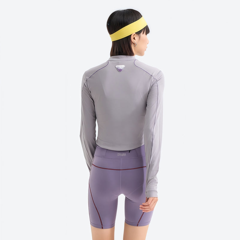 Women's stretchy fitted tee for outdoor - light gray half-zip long sleeve tee on women with headband, back standing view