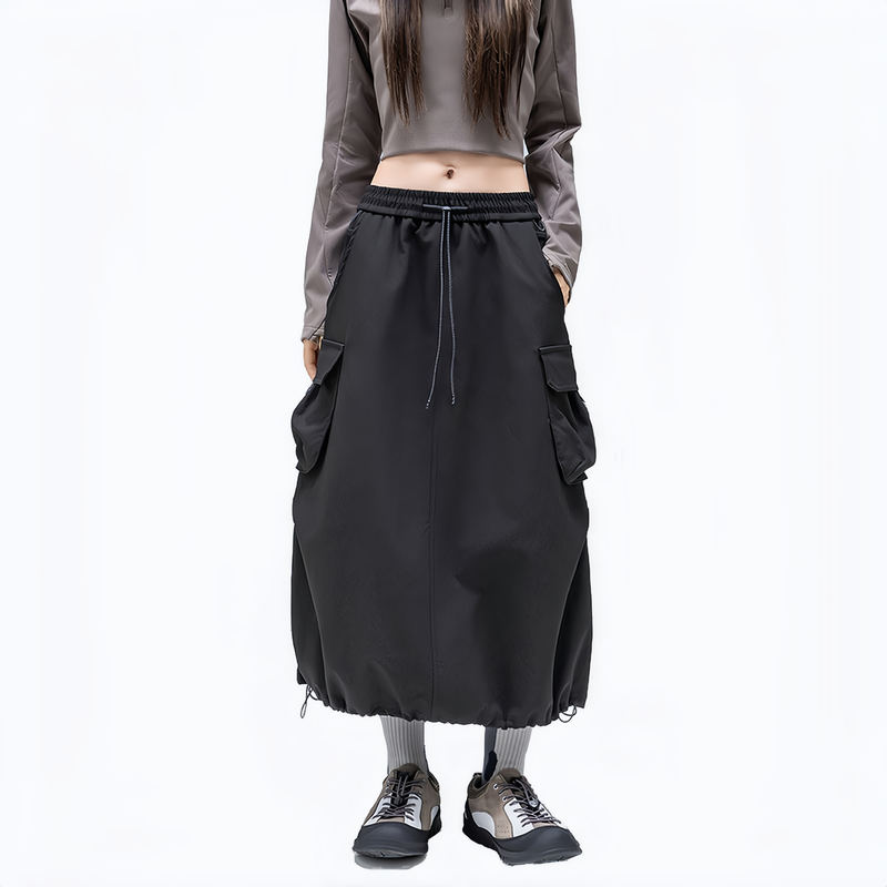 Cargo pocket outdoor long skirt for women - black cargo long skirt on women, front standing view, for travel and city walks