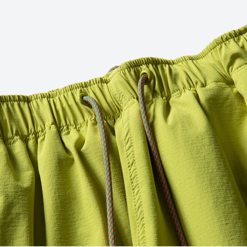 Unisex lightweight outdoor cargo pants - lime green, waistband drawstring close-up detail, for camping and travel