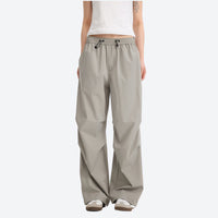 
                  
                    Water-repellent cargo hiking pants with drawcord hem - light gray wide-leg cargo pants with white tee, front standing view
                  
                