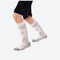 
                  
                    Kids cushioned compression socks for snow play - gray kids compression merino ski socks on feet, for kids sports and training
                  
                