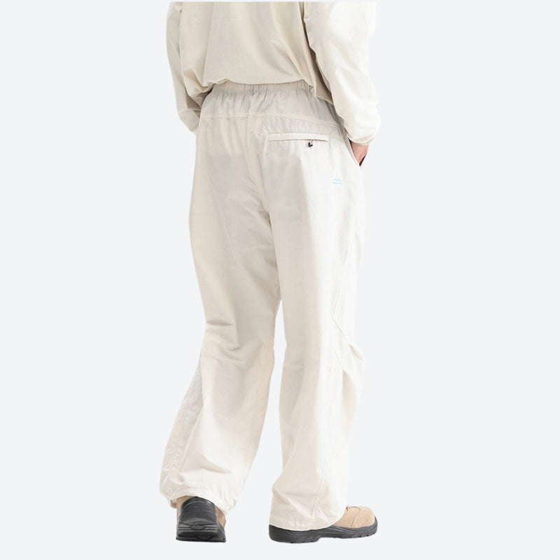 Unisex quick-dry water-repellent hiking pants - cream white wide-leg hiking pants with cream top, back walking view