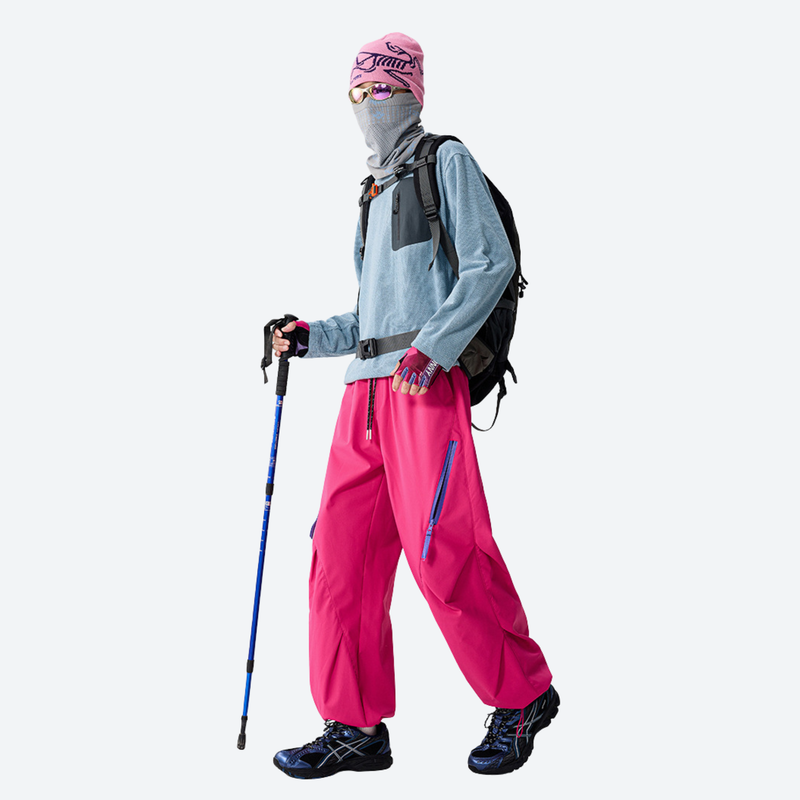 Breathable 650+ fill power duck down snow pants - pink down pants with blue top and pink beanie, walking view