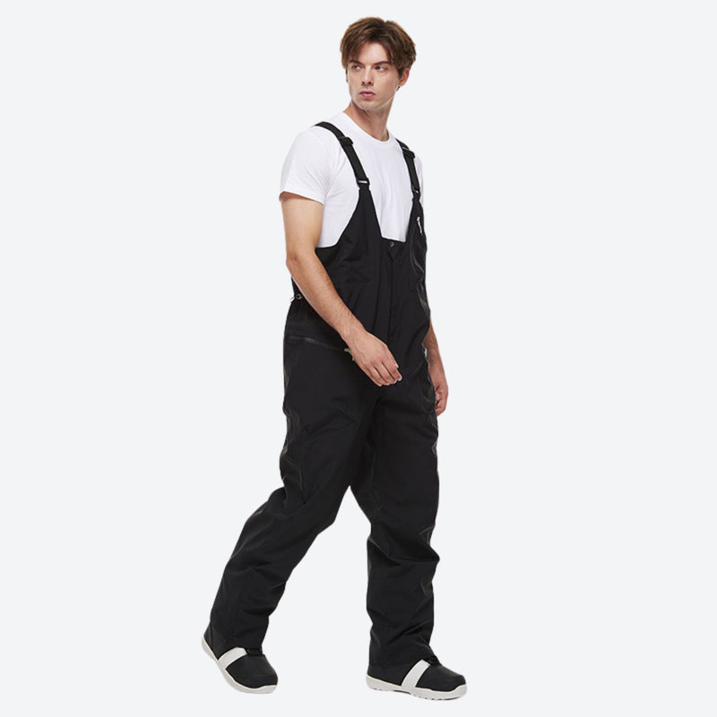 Unisex snowboard jacket and bibs set - black bib pants, on-model walking three-quarter view, for skiing and snowboarding