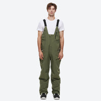
                  
                    Unisex waterproof 2L snow jacket and bib pants - olive green bib pants, on-model front view, for powder and piste riding
                  
                
