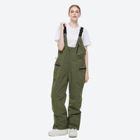 
                  
                    Unisex snowboard jacket and bibs set - olive green bib pants, on-model front view, for cold-weather winter sports
                  
                