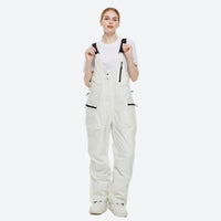 
                  
                    Unisex waterproof 2L snow jacket and bib pants - white bib pants, on-model front view, for cold-weather winter sports
                  
                