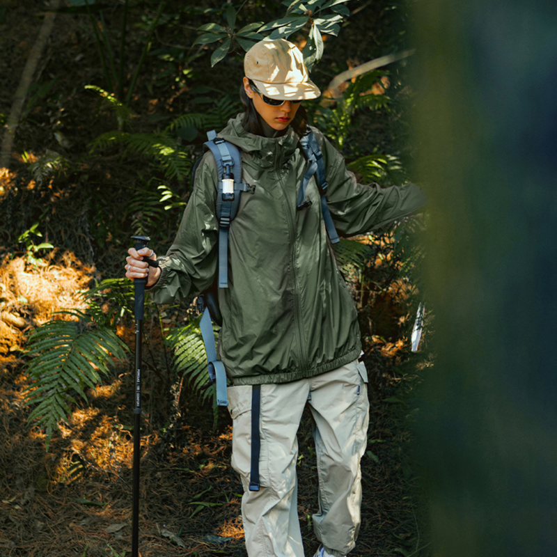 Water and oil resistant sun protection jacket - olive waterproof sun jacket on men with cap, for cycling and commuting