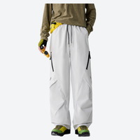 
                  
                    Unisex waterproof 2-in-1 down pants with liner - white down pants with olive top, front view, for resort and backcountry days
                  
                
