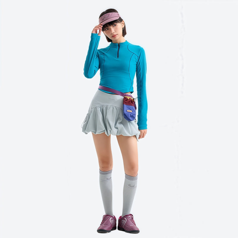 Women's stretchy fitted tee for outdoor - lake blue half-zip long sleeve tee on women with cap, front view with hand at cap