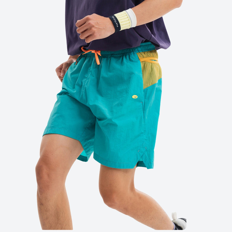 Lightweight trail shorts with back pocket - teal water-repellent shorts with purple tee, for warm-weather trekking