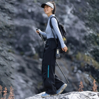
                  
                    Water-repellent fleece hiking pants for cold days - black fleece-lined hiking pants with light blue top
                  
                