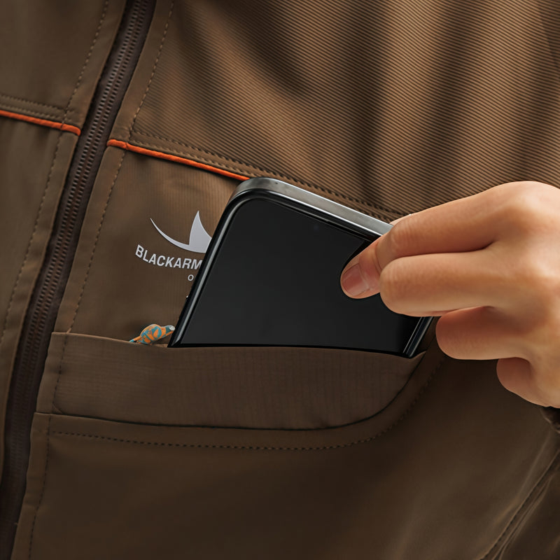 Unisex waterproof softshell jacket and cargo pants - tan, pocket close-up with hand and phone, for hiking and travel