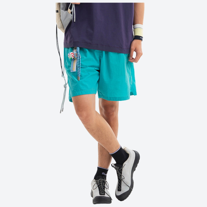 Lightweight trail shorts with back pocket - teal water-repellent shorts with purple tee, for hiking and trail walking