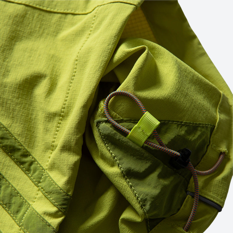 Unisex waterproof softshell cargo hiking pants - lime green, hem drawstring close-up detail, for camping and travel