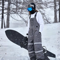 
                  
                    Unisex waterproof 3L bib snow pants - gray bib pants with white top, for powder days and winter commute
                  
                