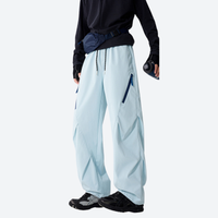 
                  
                    Unisex waterproof 2-in-1 down pants with liner - ice blue down pants with black top, front view, for skiing and snowboarding
                  
                