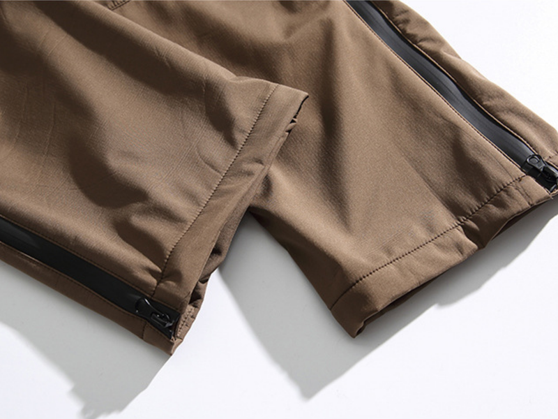 Men's water-repellent stain-resistant work trail pants - brown, hem zip open close-up, for cold-weather trekking