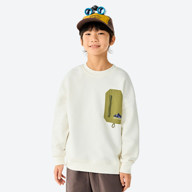 Kids' cozy fleece pullover with contrast pocket - cream kids fleece sweatshirt with olive pocket and cap, front standing view