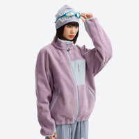 
                  
                    Soft wavy fleece jacket with contrast chest pocket - lavender wavy fleece mid-layer jacket on women with beanie and goggles
                  
                