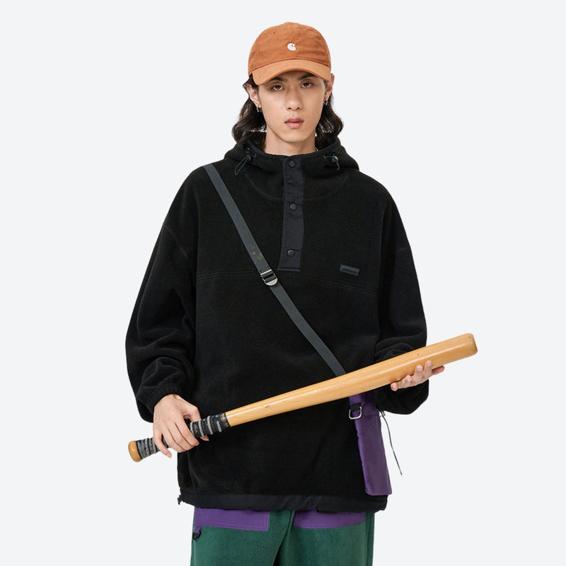 Breathable hooded pullover anorak with snap front - black hooded mid-layer pullover with cap, front view holding bat