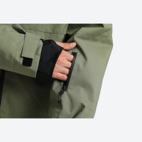 
                  
                    Men's 2-layer snowboard jacket and pants set - olive green, cuff strap close-up with hand, for resort and street wear
                  
                