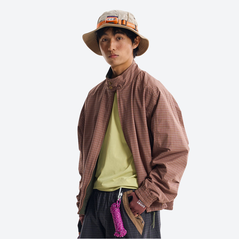 Unisex two-face softshell snowboard jacket - brown reversible jacket, front view with bucket hat, for skiing and snowboarding