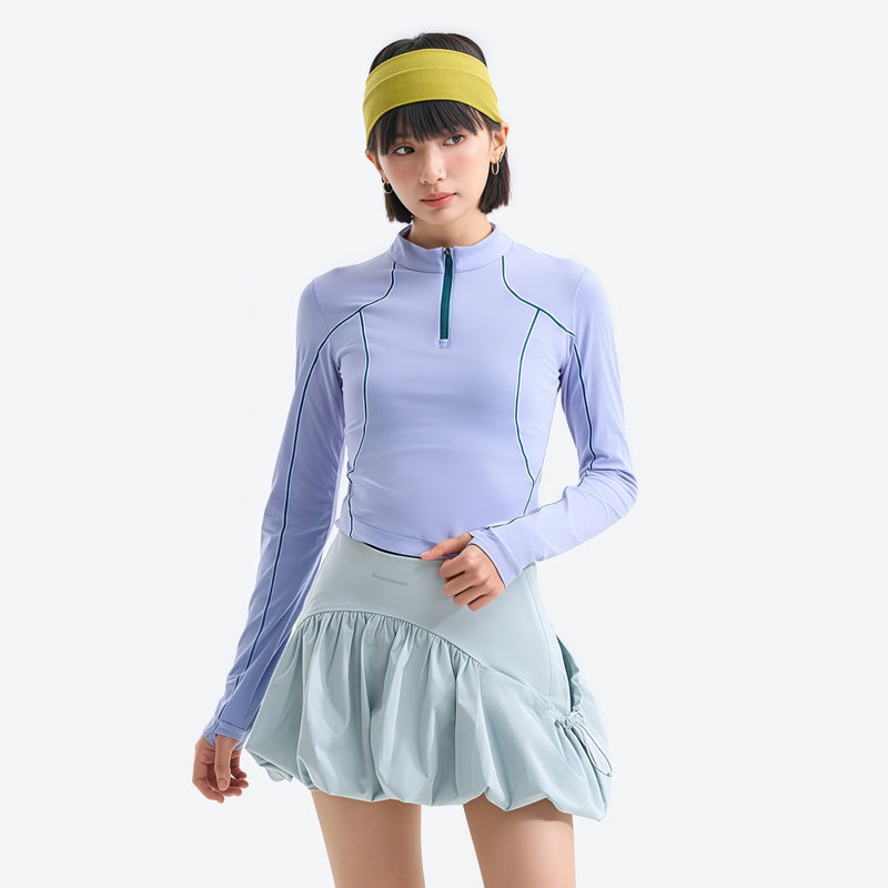 Women's fitted quick-dry breathable tee - periwinkle half-zip long sleeve tee on women with headband, front view with skirt