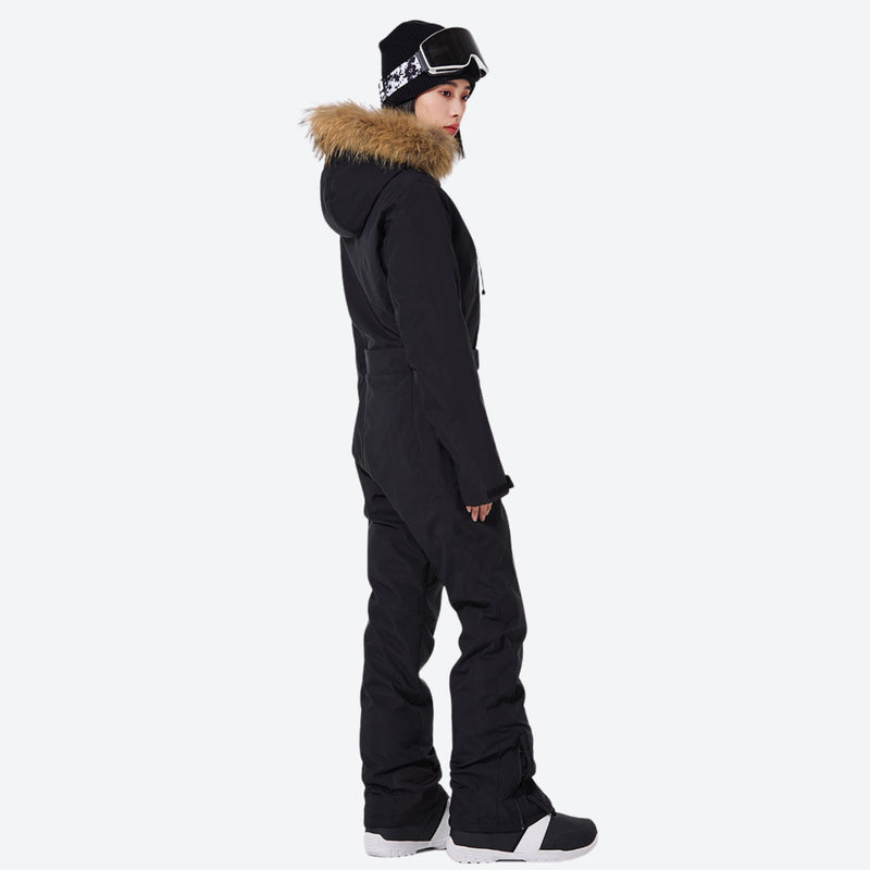 Women's waterproof 3L one-piece snow suit - black one-piece snow suit, on-model side view, for powder and piste riding