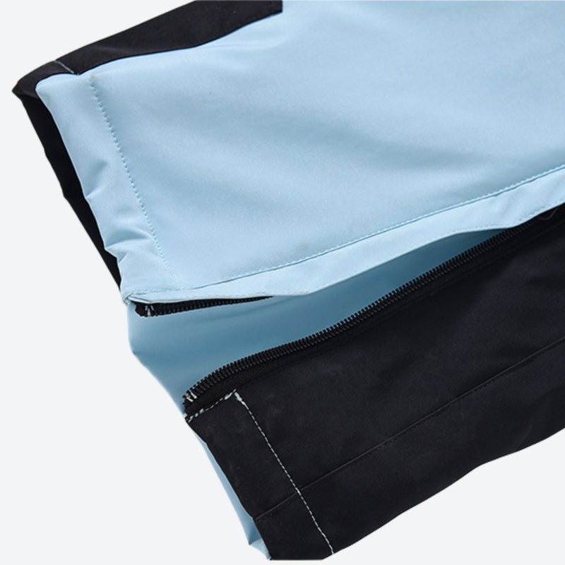Women's breathable 3-layer jumpsuit with fur hood - ice blue, hem zip close-up detail, for resort and backcountry days