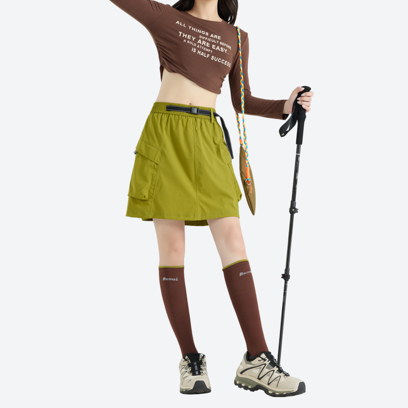 Women's quick-dry hiking skirt with inner shorts - olive green cargo skort with built-in shorts, side view with pole raised