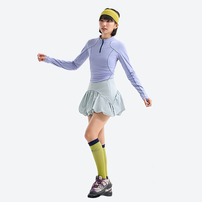 Women's fitted quick-dry breathable tee - periwinkle half-zip long sleeve tee on women with headband, walking view with skirt