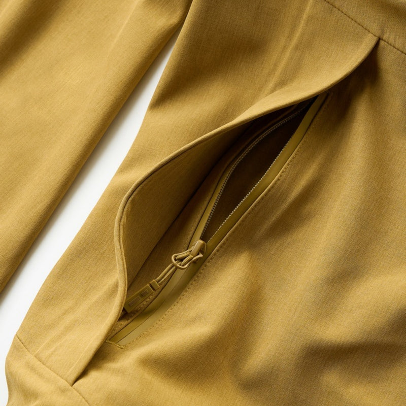 Breathable seamless bonded ski jacket with hood - mustard, pocket opening close-up detail, for powder days and winter commute