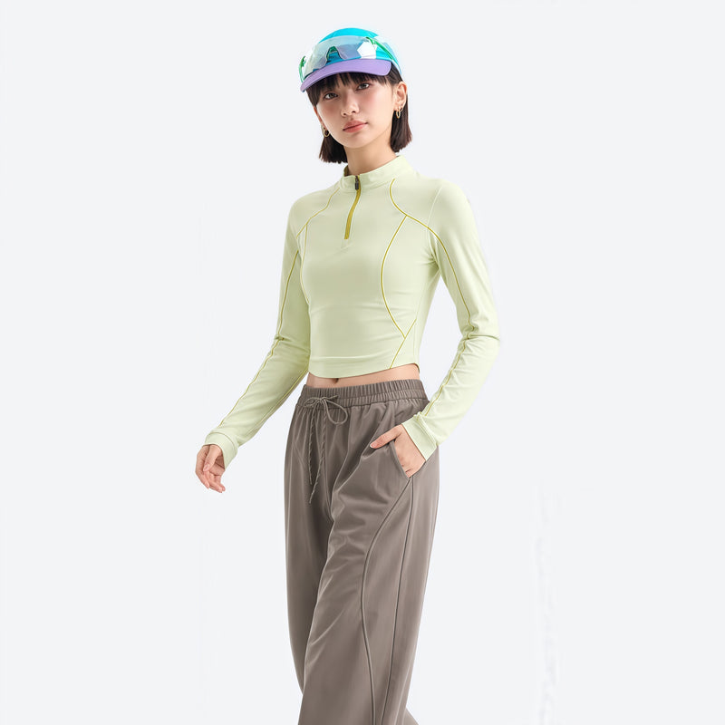 Women's wrinkle-resistant half-zip top - lime cream half-zip long sleeve tee on women with cap, front standing view