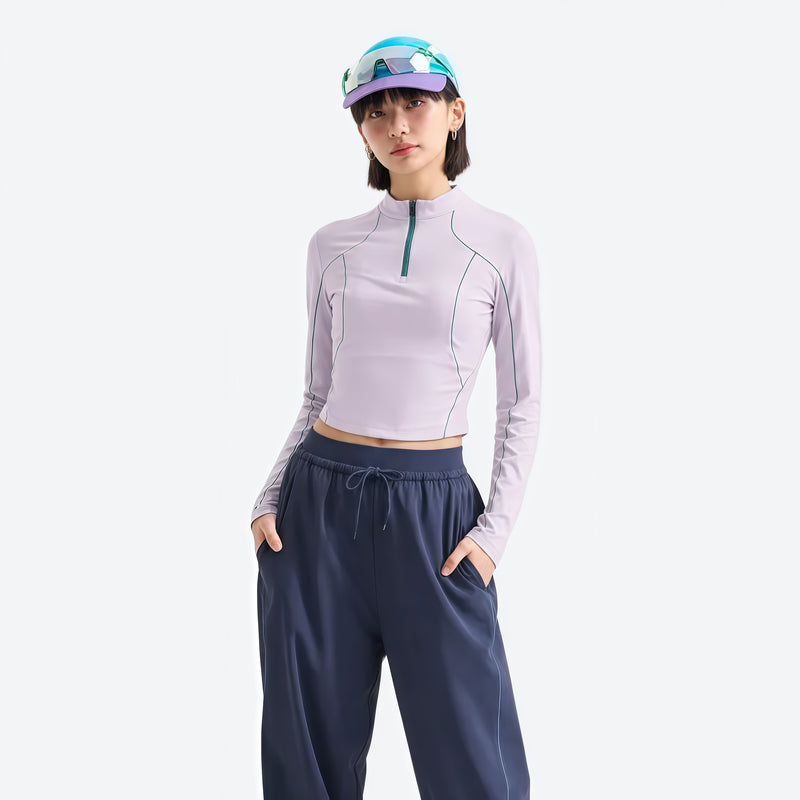 Women's fitted quick-dry breathable tee - lavender white half-zip long sleeve tee on women, front view with dark pants