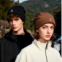 
                  
                    Soft merino wool knit hat for cold weather - black and brown merino beanie on couple, for winter mountain trips
                  
                