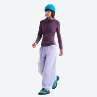 
                  
                    Women's slim fit sun jacket UPF50 antibacterial - purple slim fit sun jacket on women with blue beanie, walking side view
                  
                